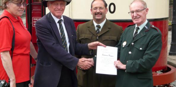 Lawrence being presented with his certificate