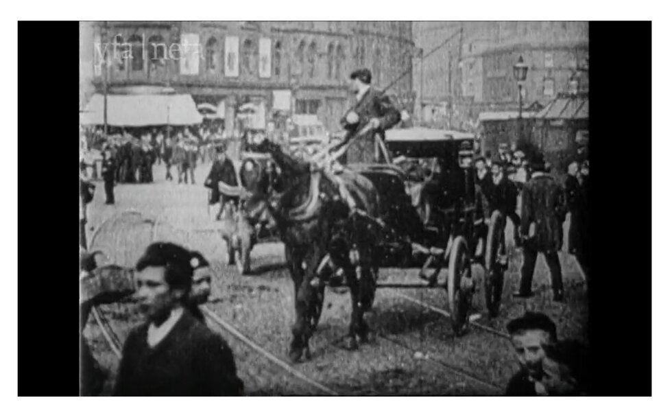 Film showing Bradford Town Hall Square in 1896 (copyright Yorkshire and North east Film Archives). Peopl are walking around the square, there are horse and carriages and also a steam tram.