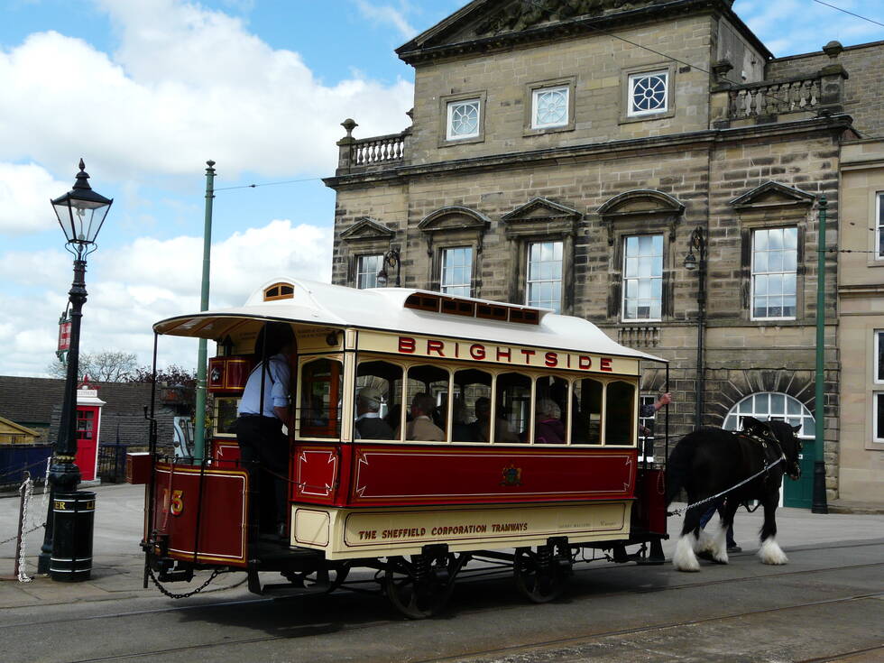 A horse pulling a tram full of people at Crich Tramway Museum.