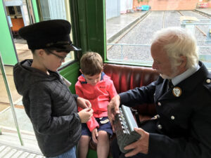 Children learning about the role of tram conductor